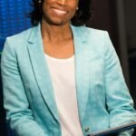 Smiling woman in data center showcasing technology expertise.